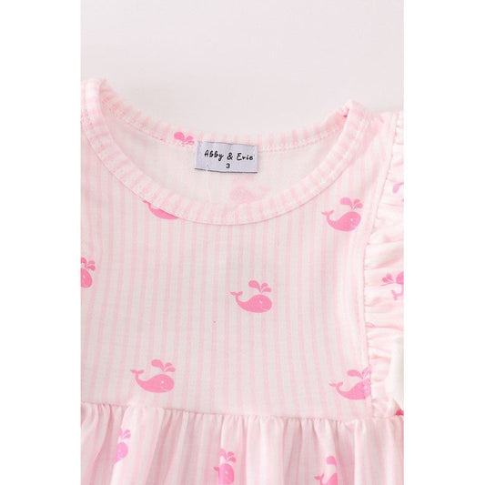 closer view of the neckline- featuring pink strips and whales