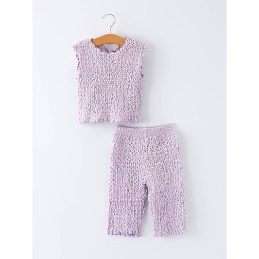 Purple textured top and pants set on a hanger against a white background