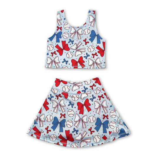 Children's tank top and skirt set with shorts underneath, baseball and bow pattern on a white background. set is light blue with white bows, white baseballs, blue bows, red bows