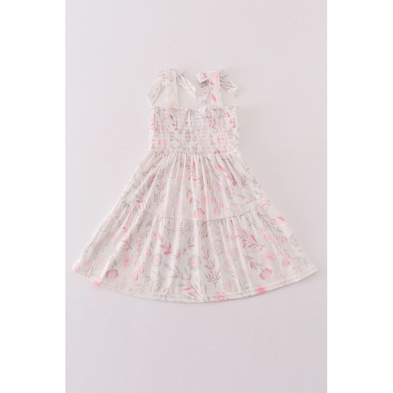 A  floral dress in shades of pink and green with bows at the shoulders, displayed on a plain background.