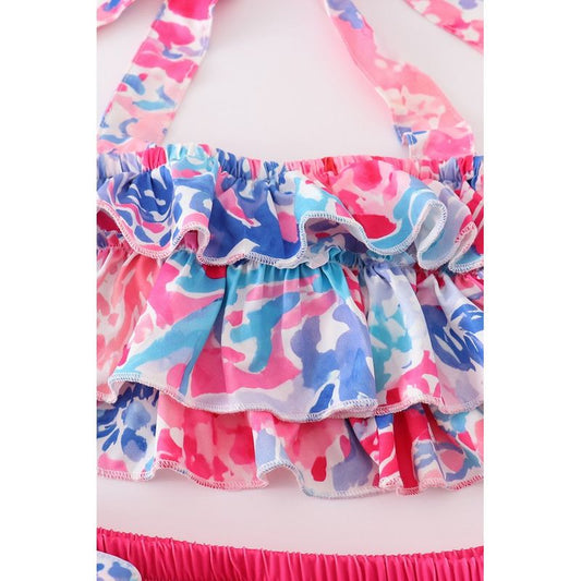 Multicolored ruffled fabric with pink, blue, and white pattern on a white background