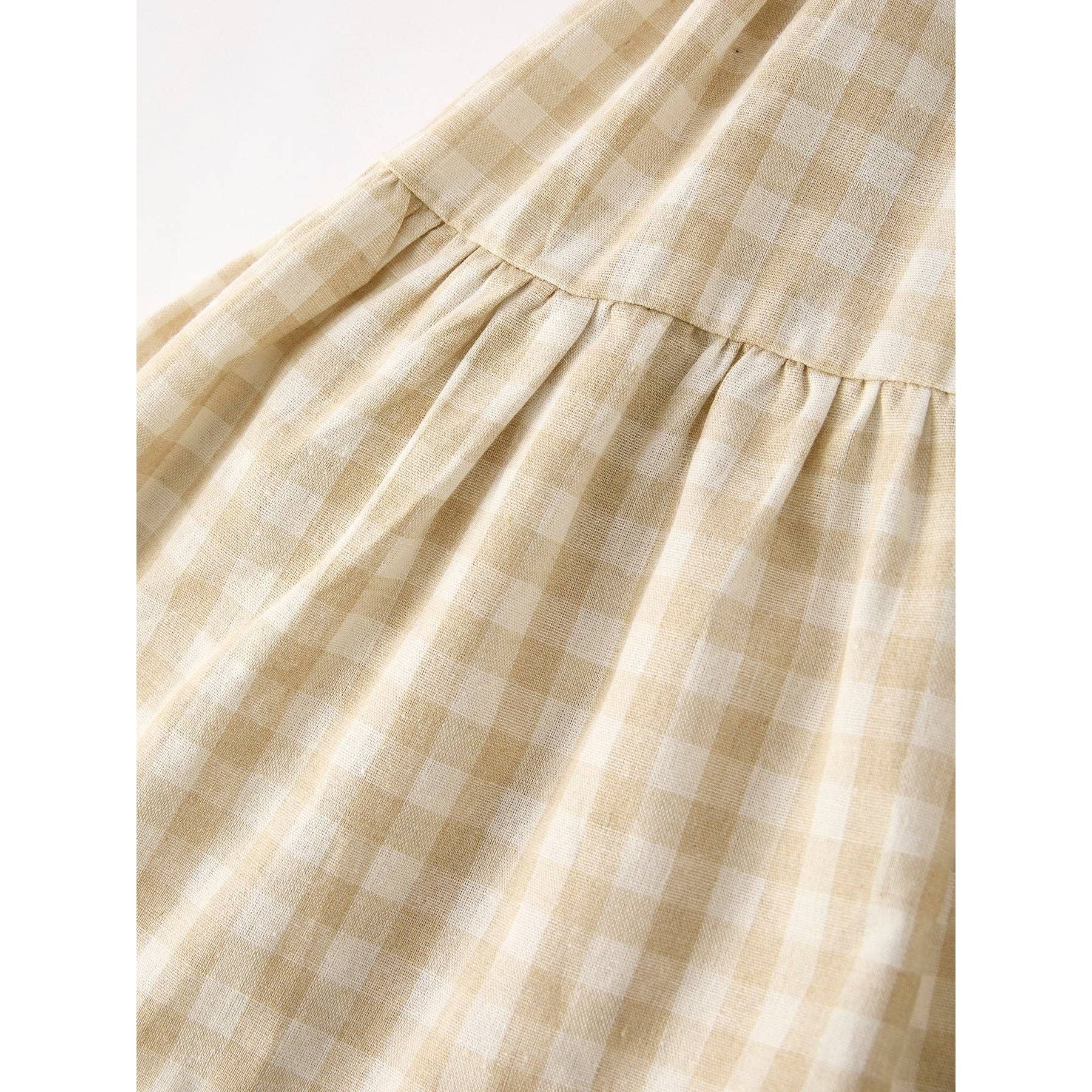 girls Easter bunny embroidered gingham dress, vintage style, beige, neutral colors, aesthetic, hanging on hanger on a neutral background, flowy skirt design on dress, close up of gingham print