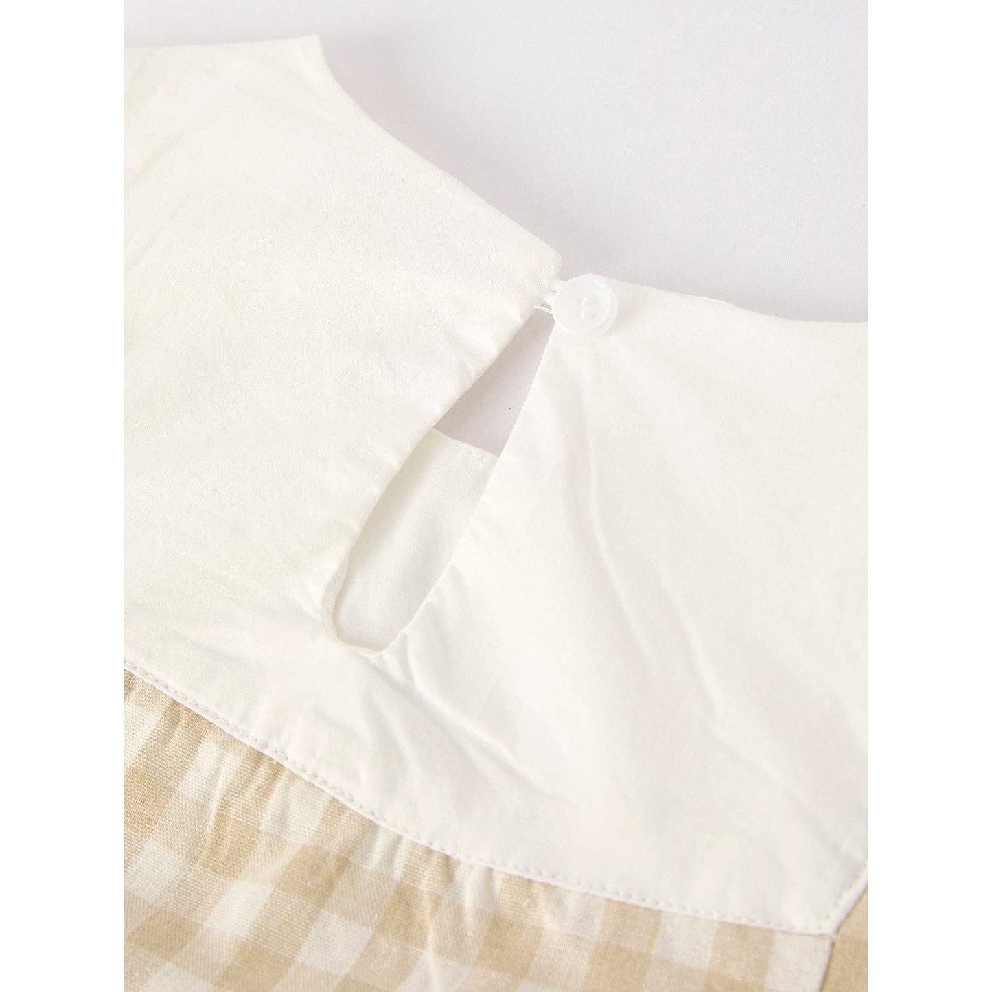 girls Easter bunny embroidered gingham dress, vintage style, beige, neutral colors, aesthetic, hanging on hanger on a neutral background, flowy skirt design on dress