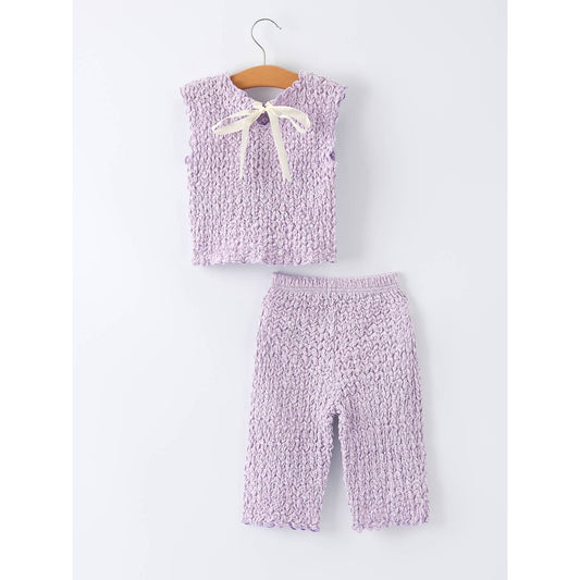 Purple knitted outfit with a bow on a white background