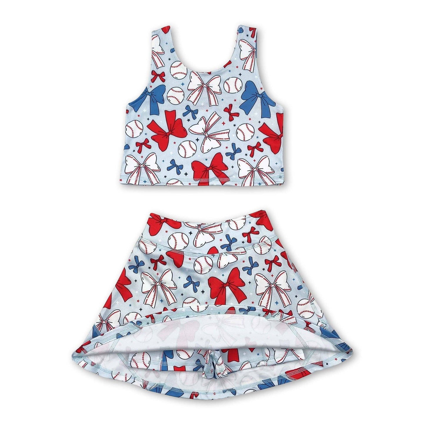 Children's tank top and skirt set with  shorts underneath, baseball and bow pattern on a white background. set is light blue with white bows, white baseballs, blue bows, red bows