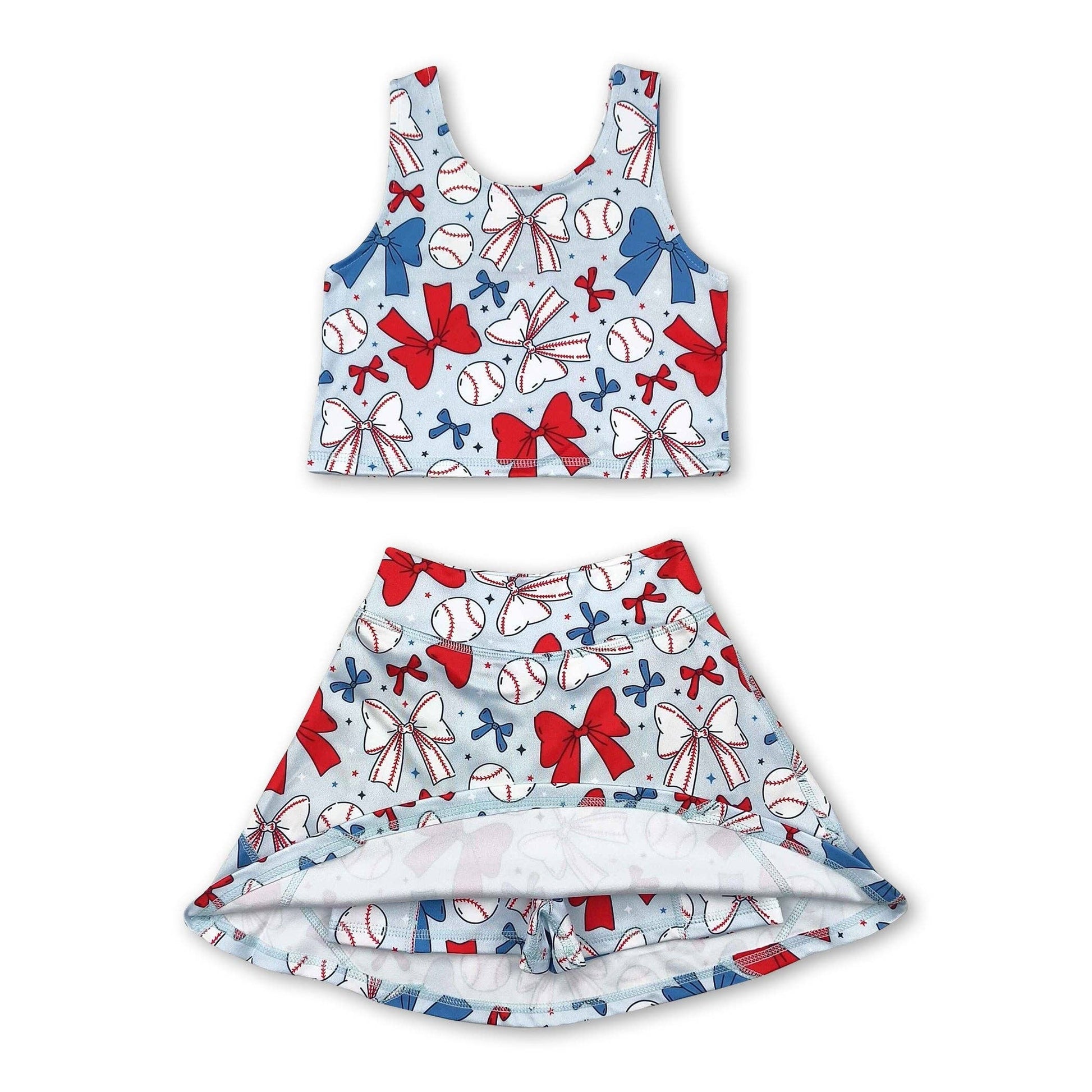 Children's tank top and skirt set with  shorts underneath, baseball and bow pattern on a white background. set is light blue with white bows, white baseballs, blue bows, red bows